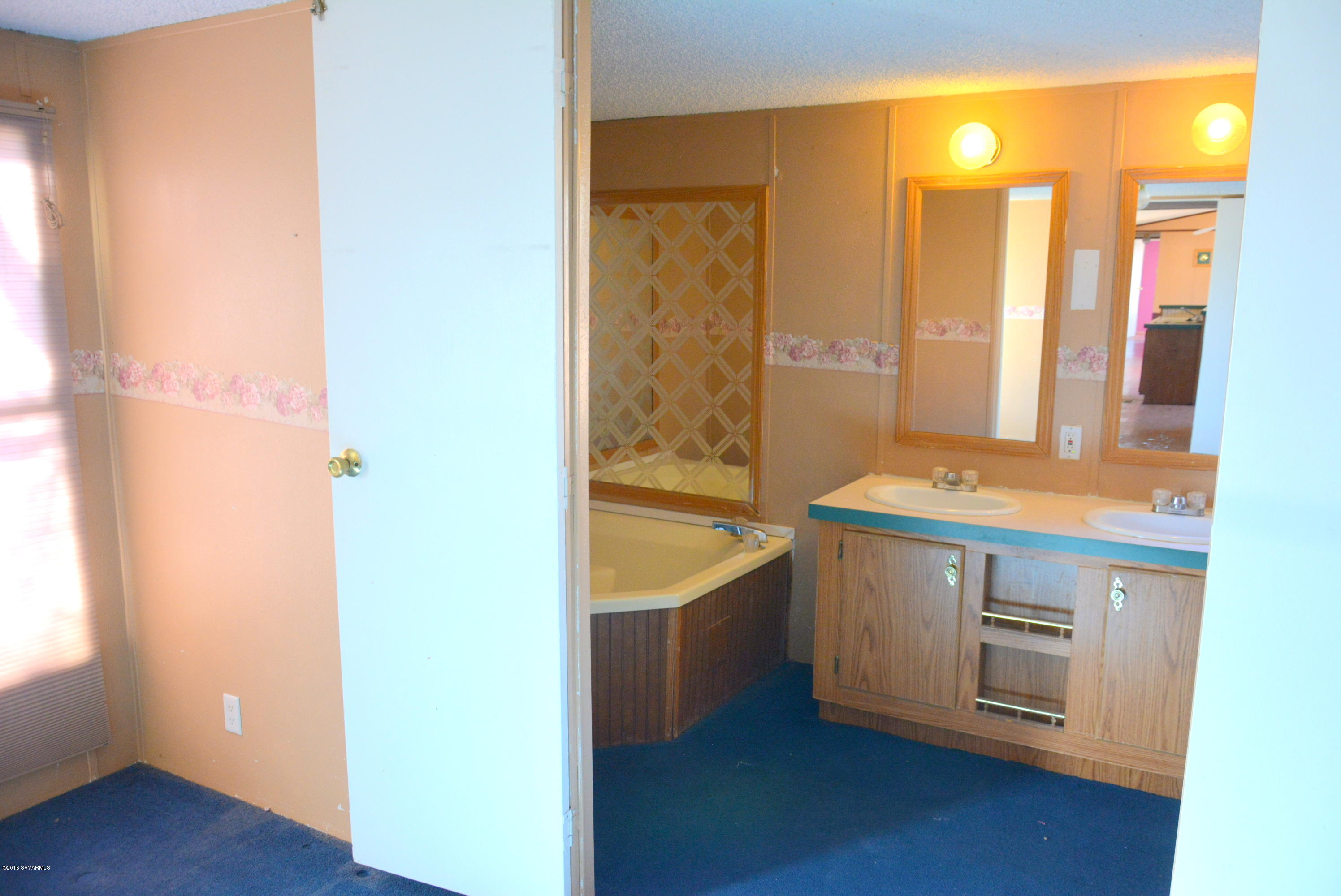 4050 Bridle Path Road Cottonwood, AZ 86326 - Photo 12 of 17 a bathroom with a granite countertop sink and a mirror