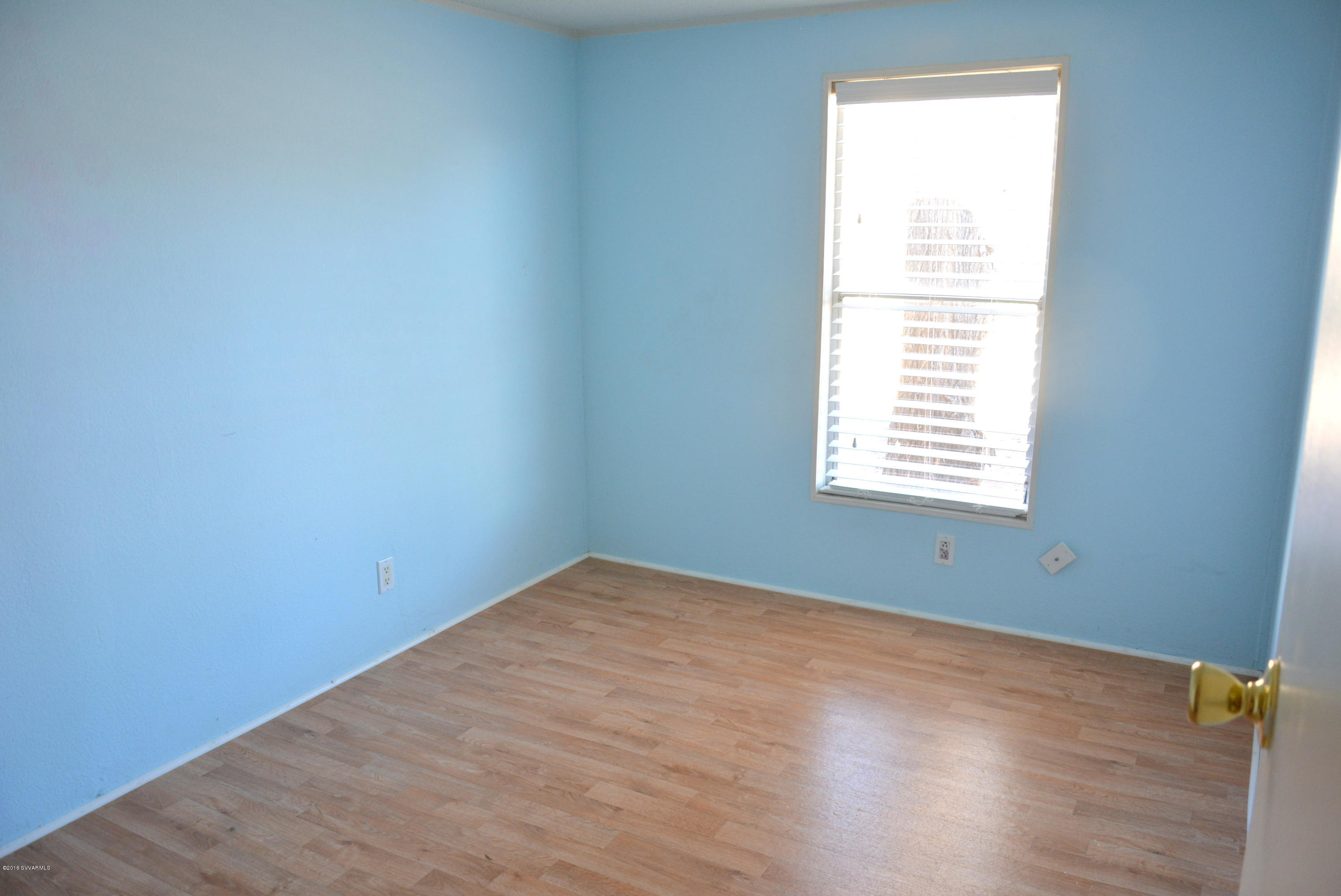 4050 Bridle Path Road Cottonwood, AZ 86326 - Photo 13 of 17 an empty room with wooden floor and a window