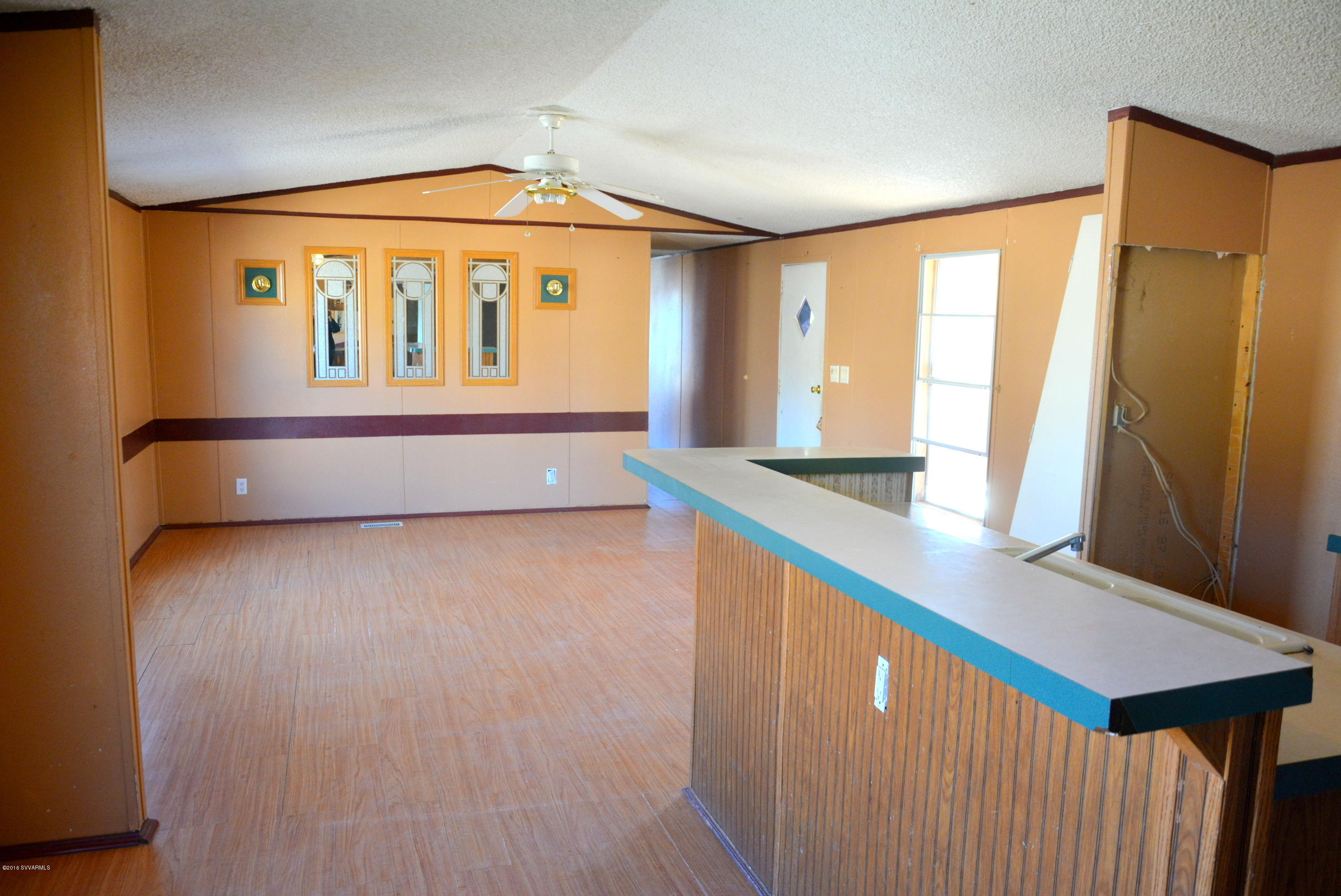 4050 Bridle Path Road Cottonwood, AZ 86326 - Photo 5 of 17 a view of an empty room with wooden floor and a window