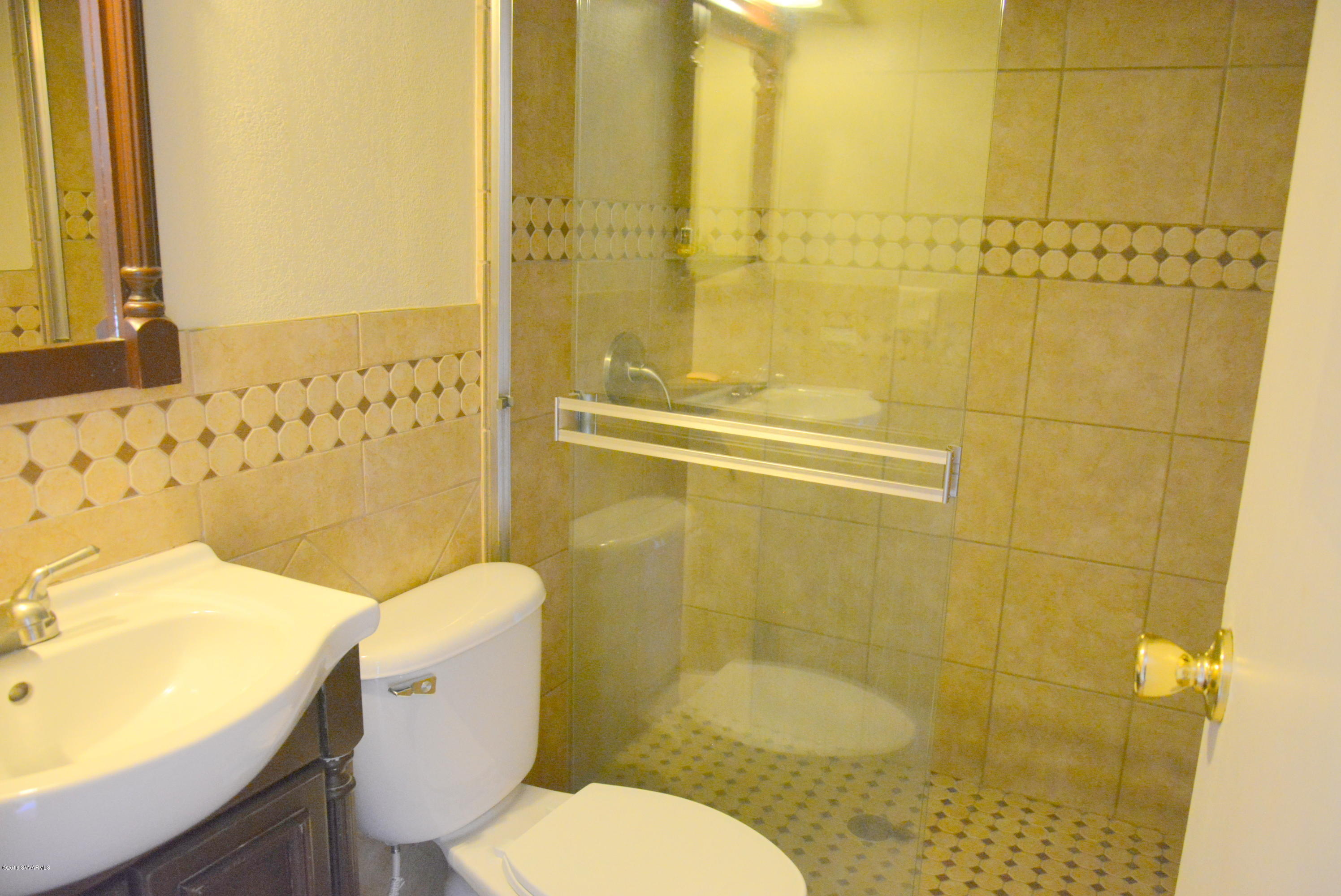 4050 Bridle Path Road Cottonwood, AZ 86326 - Photo 7 of 17 a white toilet sitting next to a bathroom sink