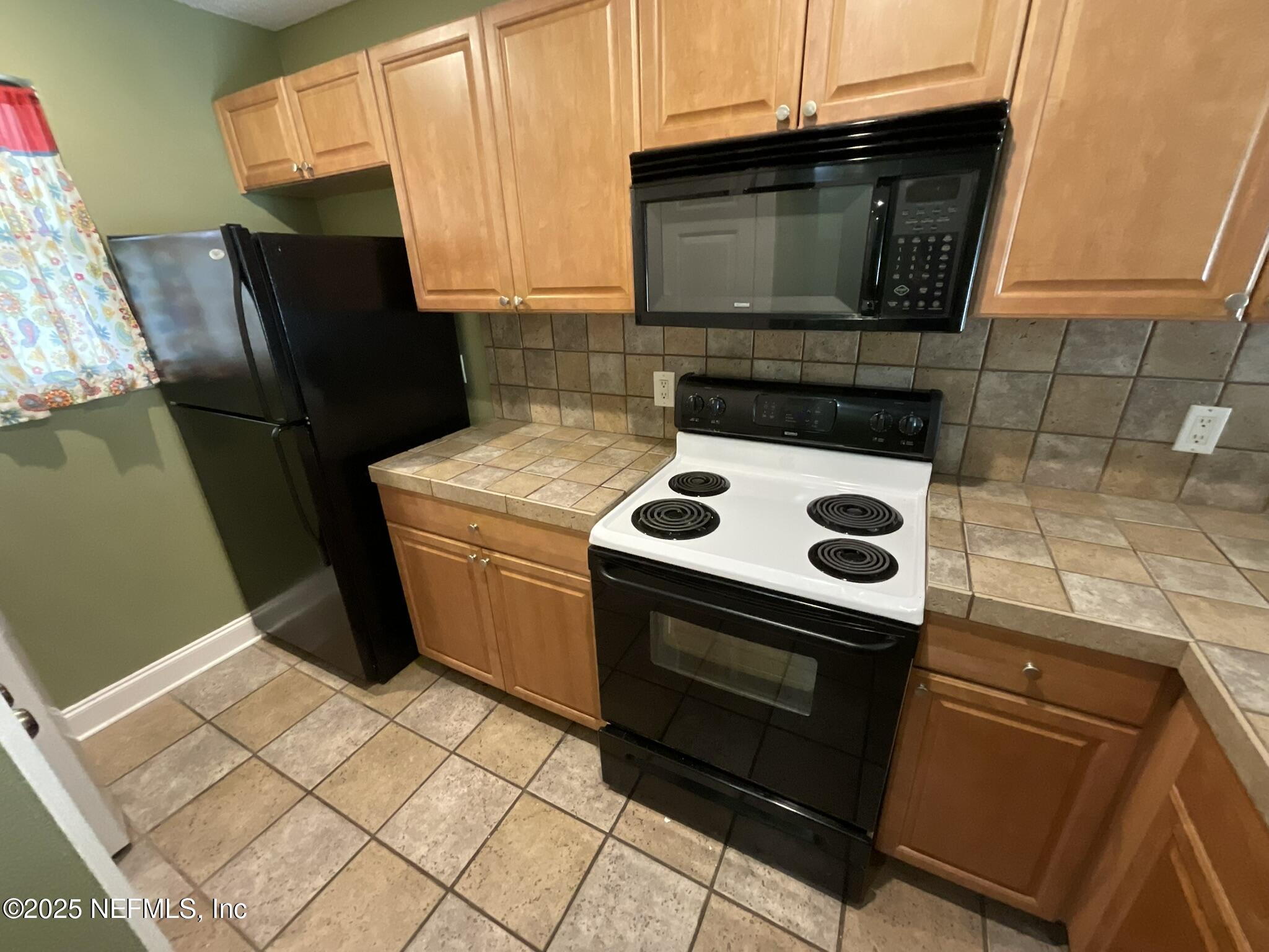650 West Pope Road, Unit 252 St. Augustine, FL 32080 - Photo 12 of 33 a kitchen with a stove microwave and refrigerator