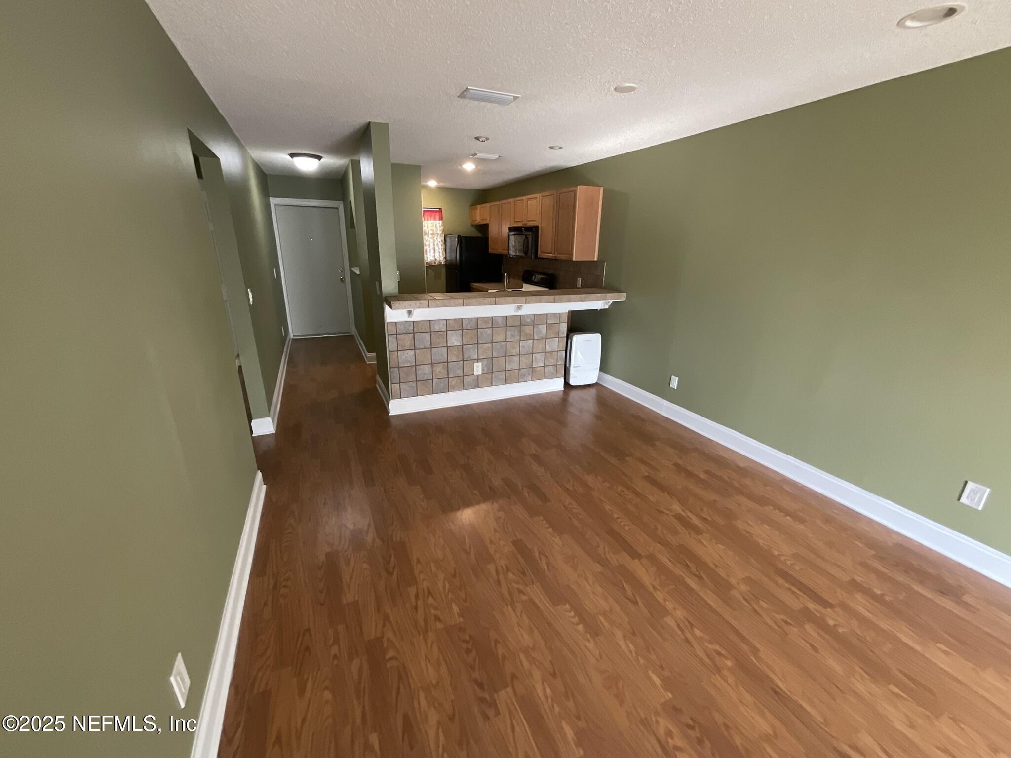 650 West Pope Road, Unit 252 St. Augustine, FL 32080 - Photo 17 of 33 a view of a kitchen with a sink and a refrigerator