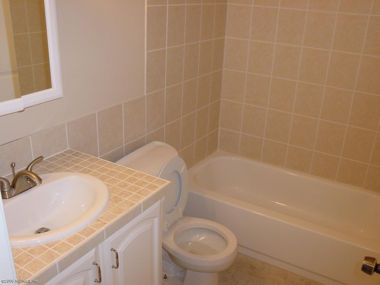 650 West Pope Road, Unit 252 St. Augustine, FL 32080 - Photo 20 of 33 a bathroom with a granite countertop sink a toilet and bathtub