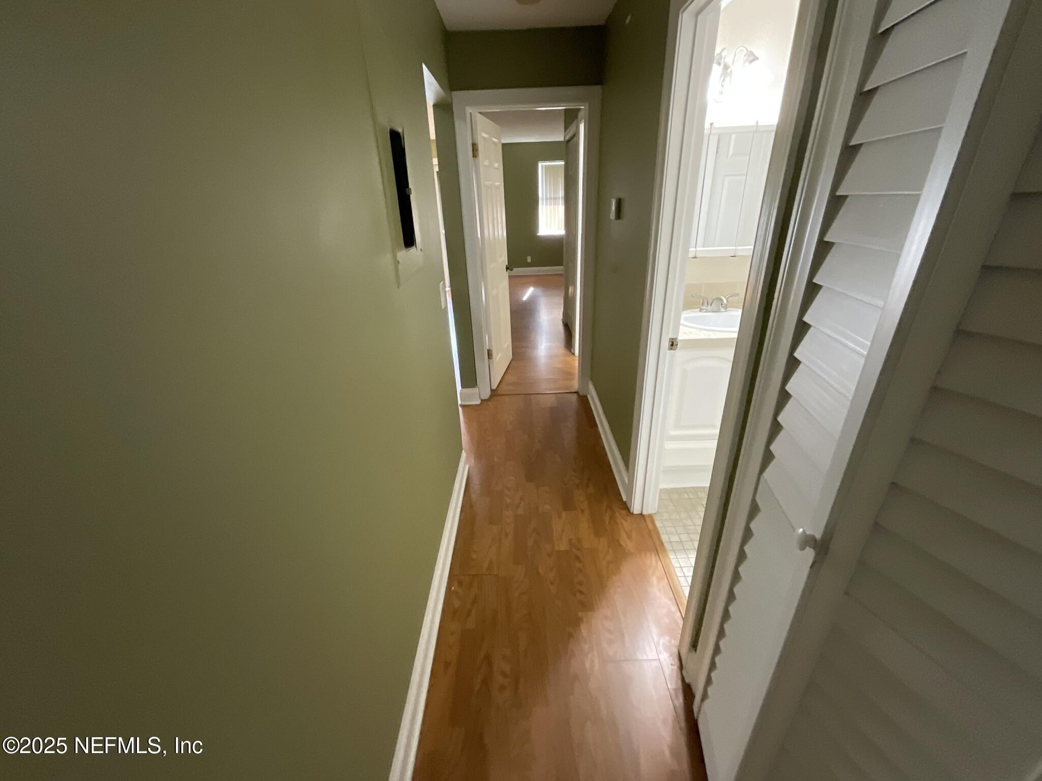 650 West Pope Road, Unit 252 St. Augustine, FL 32080 - Photo 26 of 33 a view of a hallway with wooden floor and stairs