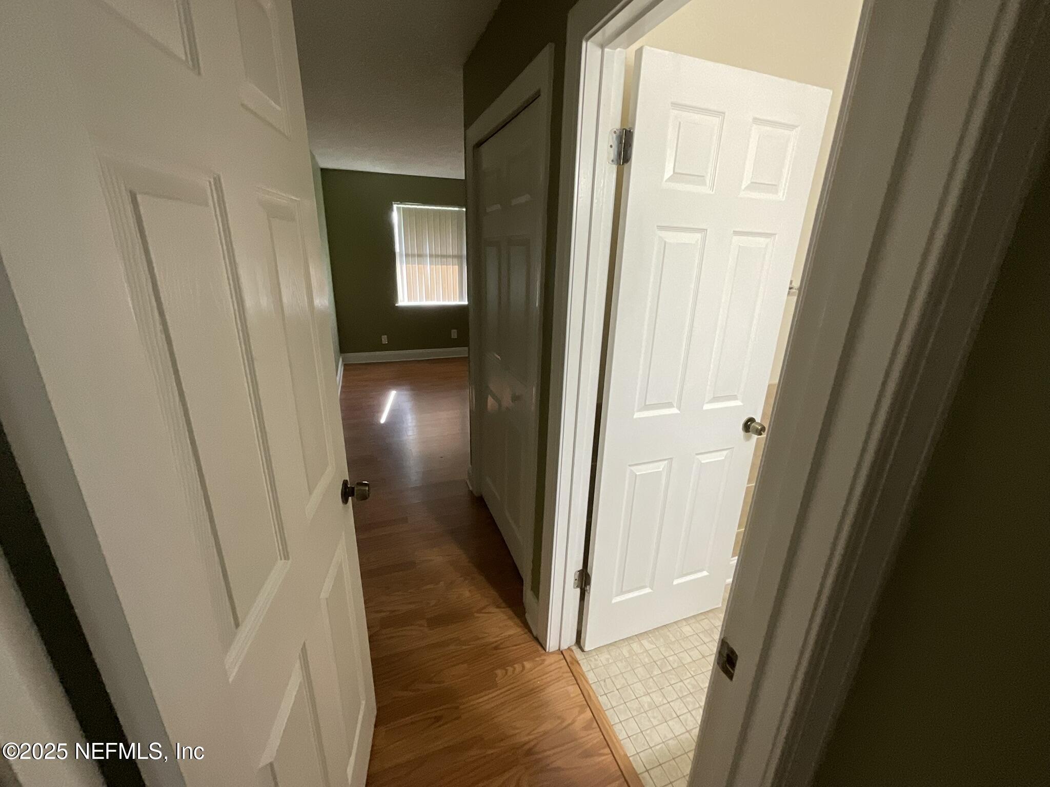 650 West Pope Road, Unit 252 St. Augustine, FL 32080 - Photo 28 of 33 a view of a hallway with wooden floor and a door