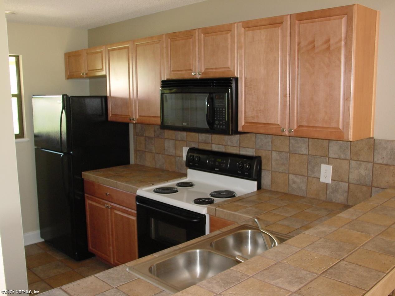 650 West Pope Road, Unit 252 St. Augustine, FL 32080 - Photo 10 of 33 a kitchen with stainless steel appliances granite countertop a refrigerator a stove and a sink