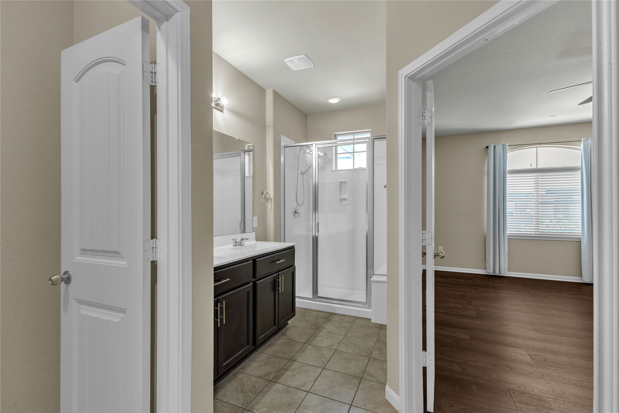2880 Donnell Drive, Unit 2003 Round Rock, TX 78664 - Photo 27 of 31 Full bathroom with dark wood-finish vanity, quartz countertop, and a shower-tub combination with glass enclosure