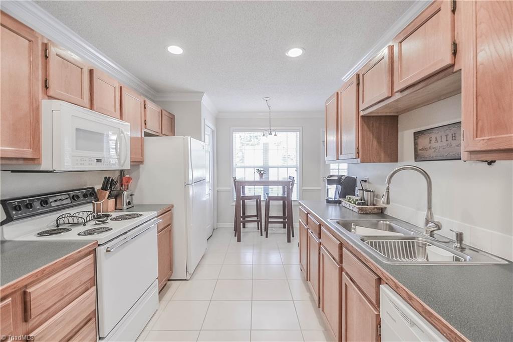133 Canton Road Advance, NC 27006 - Photo 5 of 20 Galley kitchen with lots of cabinet storage and tile floors.