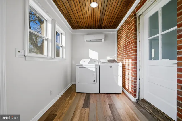 a view of a hallway with washer and dryer