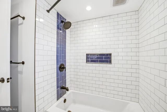 a bathroom with a bathtub and shower