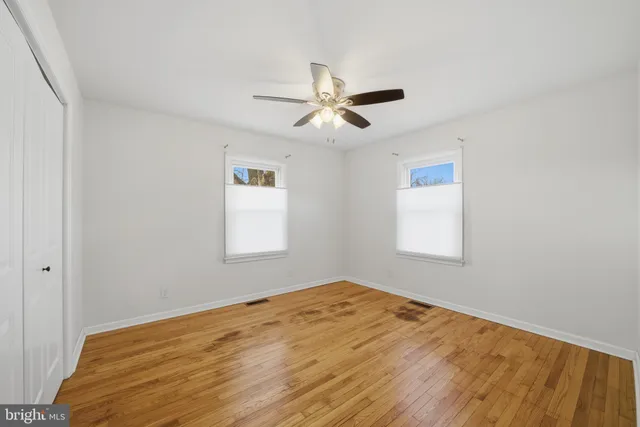 a view of a room with a window and ceiling fan