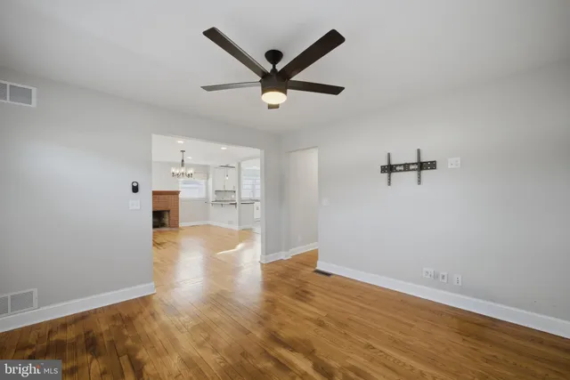 a view of a livingroom with a hardwood floor and a ceiling fan