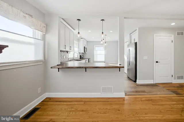 a view of kitchen with stainless steel appliances refrigerator and window