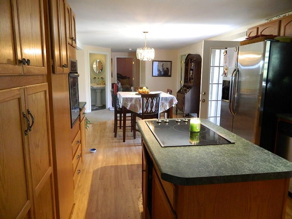 402 High Street Paris, ME 04281 - Photo 5 of 22 Kitchen has a flat top stove, wall...