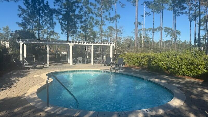 I-14 Mallard Lane Santa Rosa Beach, FL 32459 - Photo 17 of 25 a view of a house with backyard and sitting area