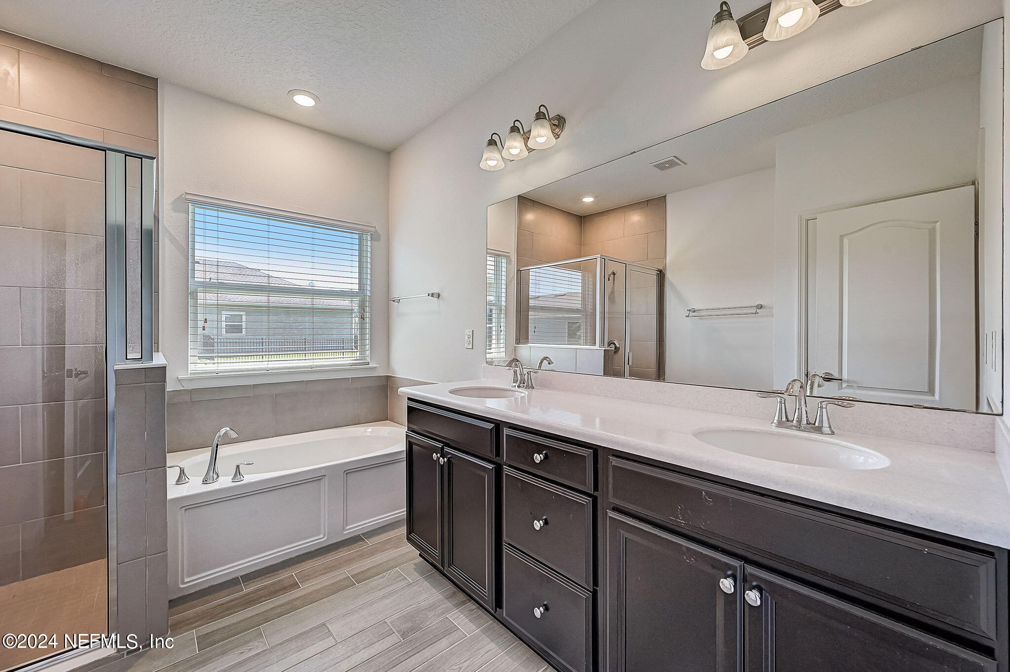 48 Martello Drive St. Augustine, FL 32092 - Photo 18 of 50 a spacious bathroom with a double vanity sink a mirror and a bathtub