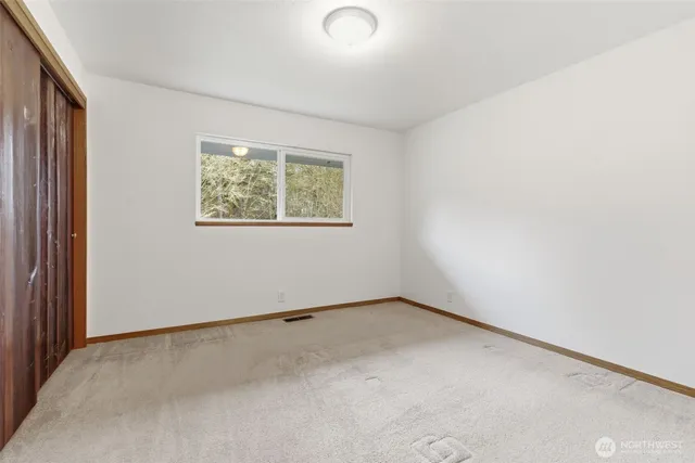 a spacious bedroom with a bed and a couch