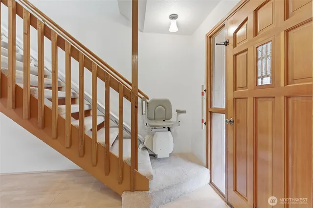 a view of entryway and hall with wooden floor