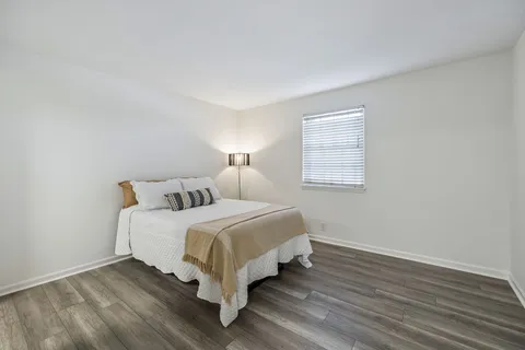 a view of a room with wooden floor