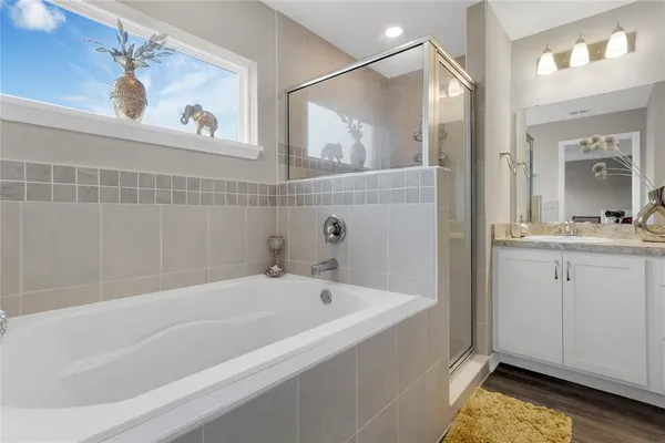 a bathroom with a tub a sink and mirrors
