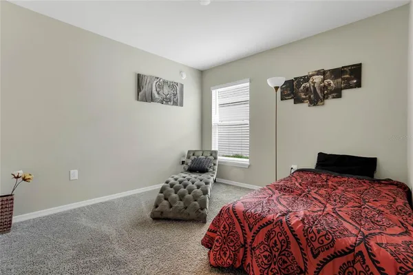 a bedroom with a bed and window