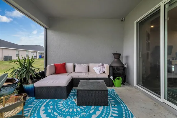 a living room with furniture floor and a potted plant