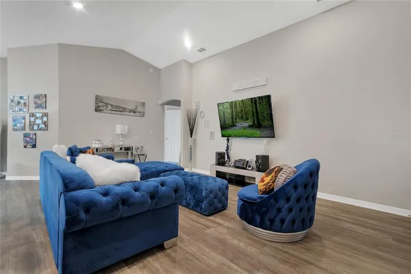 a living room with furniture wooden floor and a flat screen tv