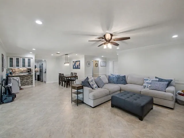 a living room with furniture and kitchen view