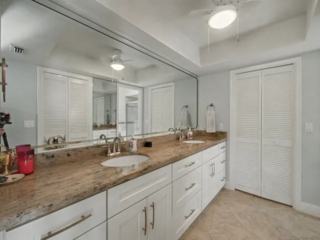 a bathroom with double sink and a mirror