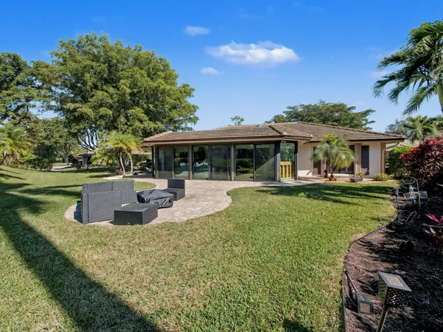 a view of a house with swimming pool and sitting area