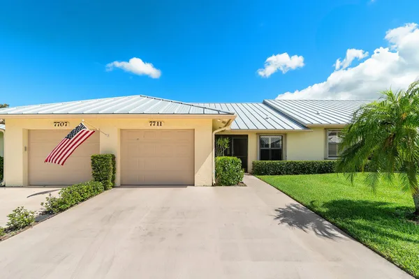 a front view of a house with a yard and a garage