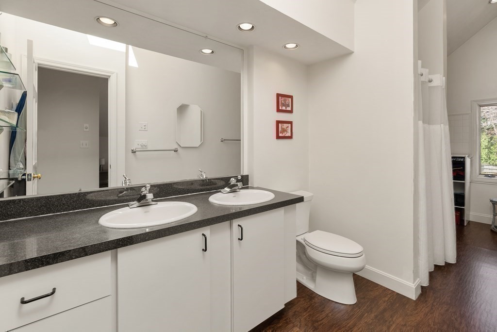 46 Downing Road Lexington, MA 02421 - Photo 17 of 29 a bathroom with a granite countertop toilet sink and mirror