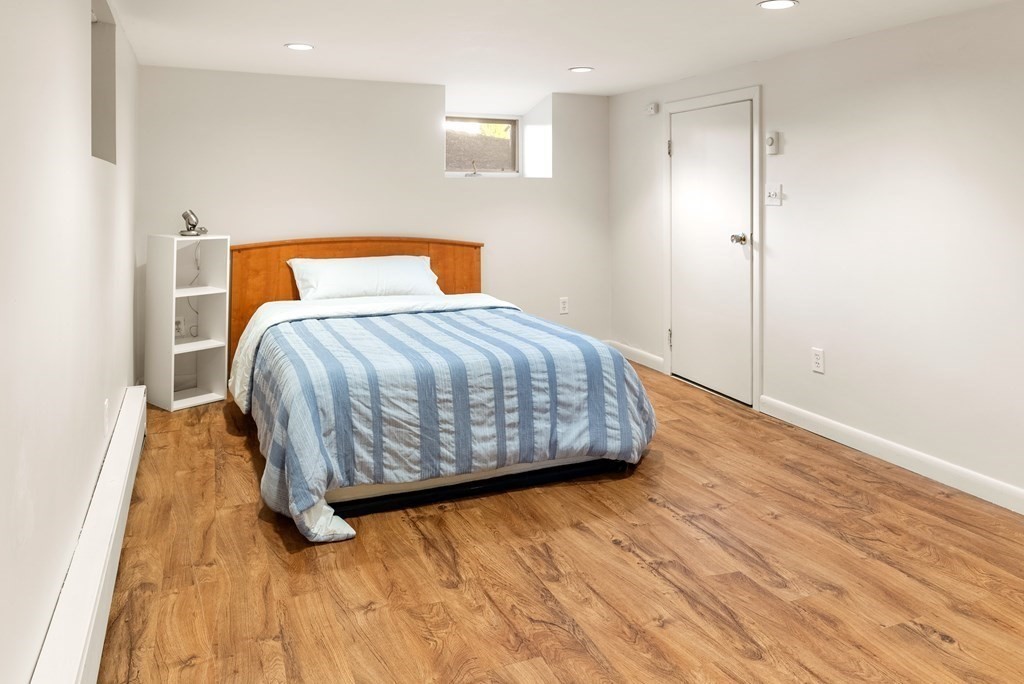 46 Downing Road Lexington, MA 02421 - Photo 22 of 29 a bedroom with a bed and wooden floor