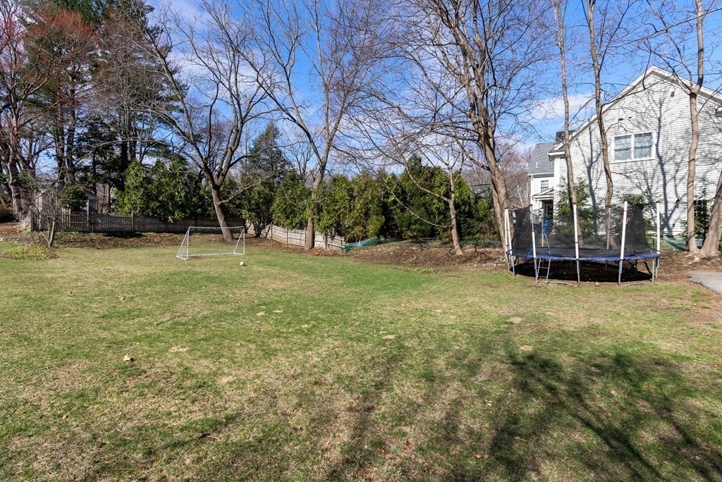 46 Downing Road Lexington, MA 02421 - Photo 25 of 29 a view of a field with trees in the background