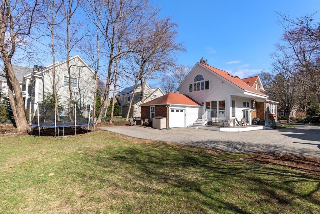 46 Downing Road Lexington, MA 02421 - Photo 26 of 29 a front view of a house with a yard covered in snow