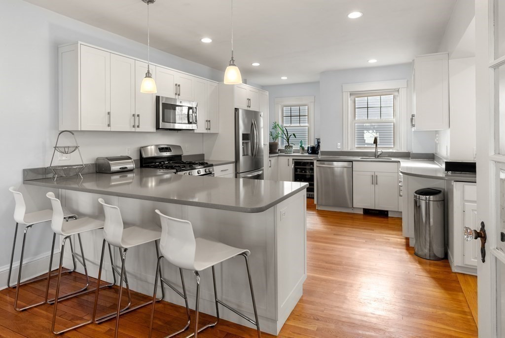 46 Downing Road Lexington, MA 02421 - Photo 8 of 29 a kitchen with stainless steel appliances granite countertop a stove top oven a sink a dining table and chairs