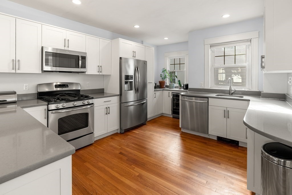 46 Downing Road Lexington, MA 02421 - Photo 9 of 29 a kitchen with granite countertop a refrigerator stove and microwave