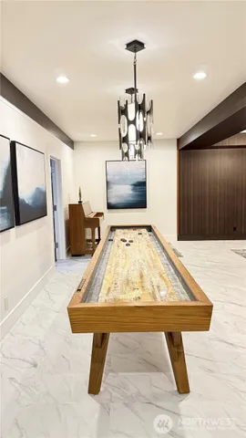 a very nice looking dining room with a rug and a chandelier