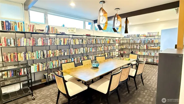 a dining room with furniture and a book shelf