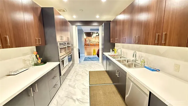 a large white kitchen with a large window