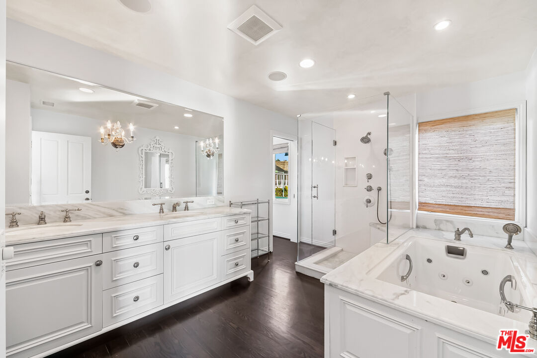 0 Broad Beach Road Malibu, CA 90265 - Photo 44 of 54 a large bathroom with a double vanity sink a mirror a bathtub and next to a window