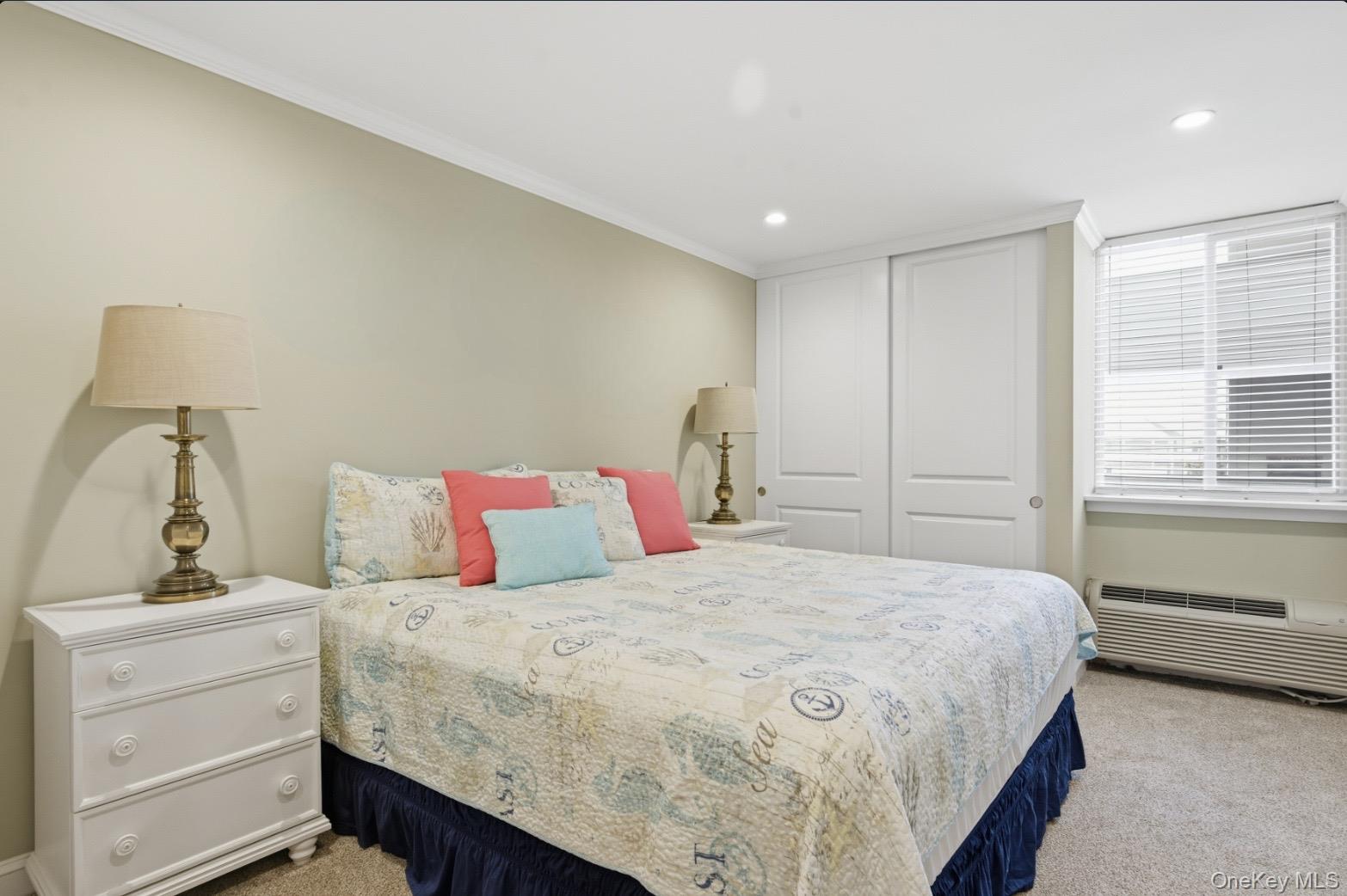 253 Dune Road, Unit 49 Westhampton Beach, NY 11978 - Photo 8 of 31 a bedroom with a bed and a window