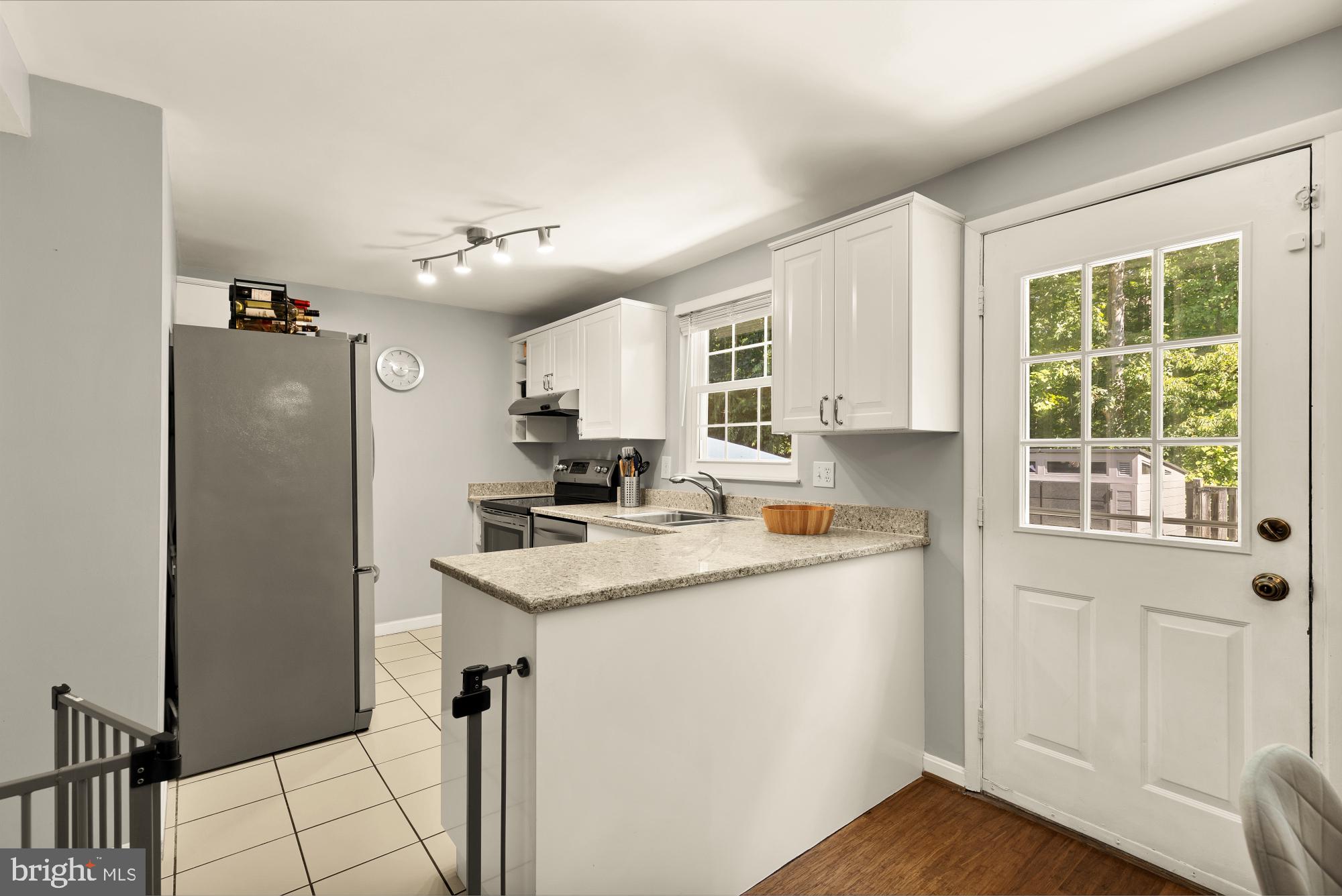 8100 Loving Forest Court Springfield, VA 22153 - Photo 11 of 33 a kitchen with a refrigerator a sink and cabinets