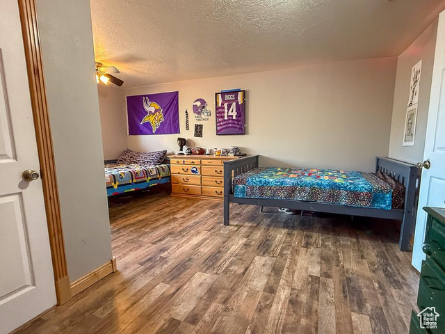 425 East Mule Deer Road Central, UT 84722 - Photo 22 of 72 Bedroom featuring wood finished floors, a textured ceiling, and ceiling fan