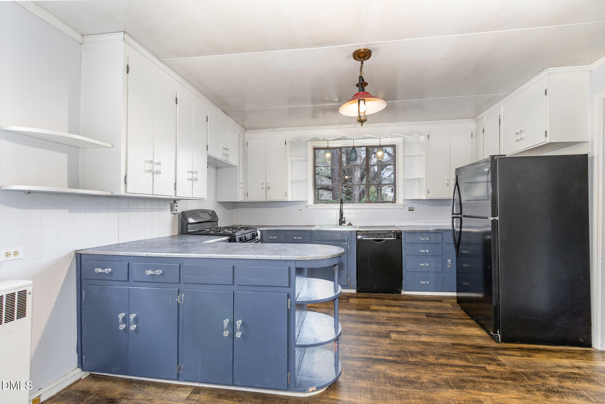2636 Chapel Hill Road Durham, NC 27707 - Photo 12 of 35 a kitchen with a sink a refrigerator and cabinets