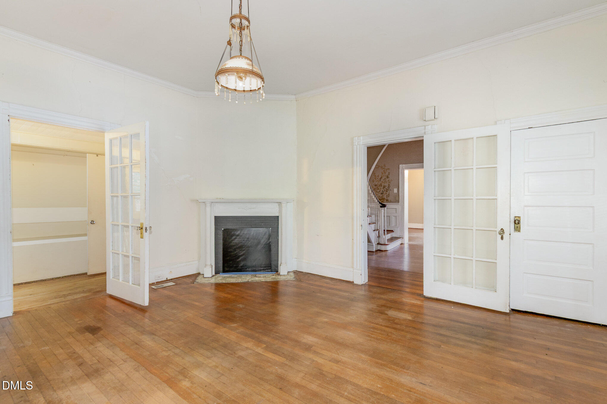 2636 Chapel Hill Road Durham, NC 27707 - Photo 17 of 35 an empty room with a fireplace and wooden floor