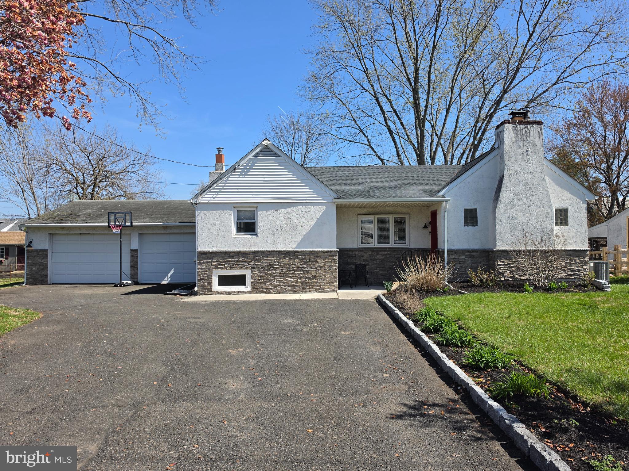 142 New Road Horsham, PA 19044 - Photo 1 of 38 a front view of a house with a yard and garage