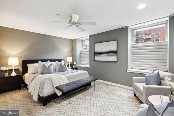a bedroom with a large bed and a couch