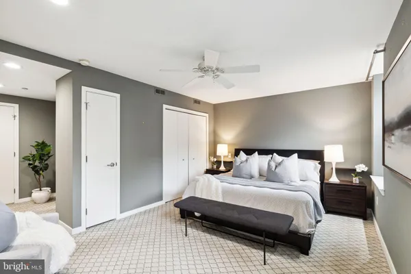 a bedroom with a bed and a couch