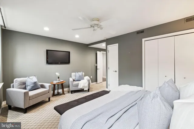 a bedroom with a bed and a couch